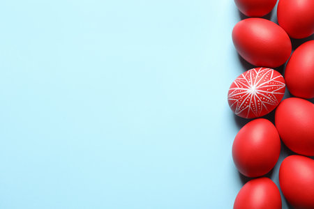 Flat lay composition of painted red Easter eggs on color background, space for textの写真素材