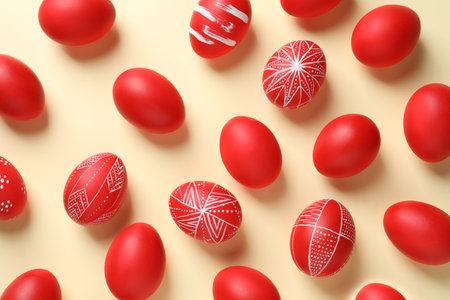Flat lay composition of red painted Easter eggs on color backgroundの写真素材