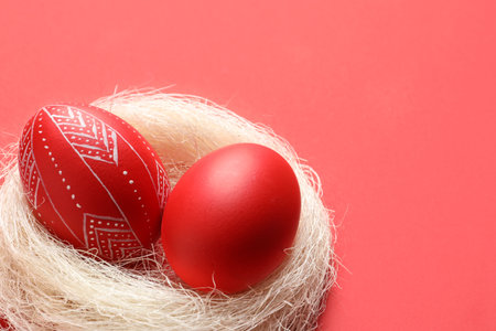 Nest with red painted Easter eggs on table, closeup. Space for textの写真素材