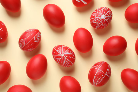 Flat lay composition of red painted Easter eggs on color backgroundの写真素材