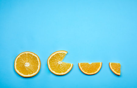 Composition with fresh orange slices and space for text on color background, flat layの写真素材