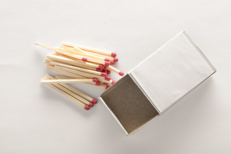 Cardboard box and matches on white background, top view. space for design