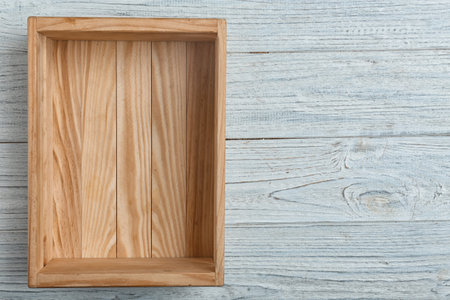 Empty crate on wooden background, top view with space for textの写真素材