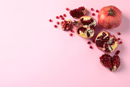 Composition with ripe pomegranates and space for text on color background, top viewの写真素材