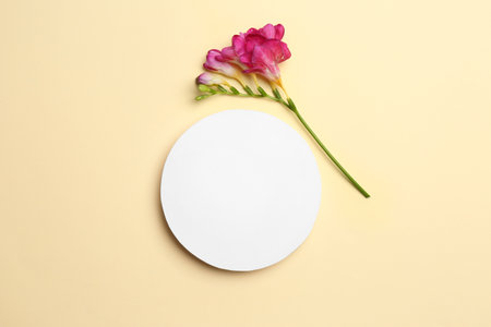 Flat lay composition with card and beautiful flower on color background, space for textの写真素材