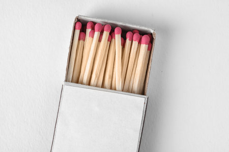 Cardboard box with matches on light background, top view. space for design