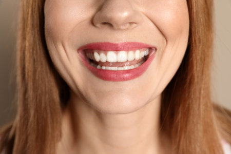 Smiling woman with perfect teeth on color background, closeupの写真素材