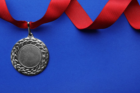 Gold medal with space for design on color background, top view. Victory conceptの写真素材