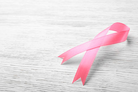 Pink ribbon on wooden background, space for text. breast cancer awareness conceptの写真素材