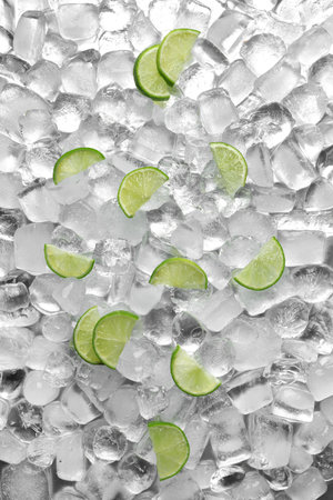 Flat lay composition with fresh lime slices on ice cubesの写真素材