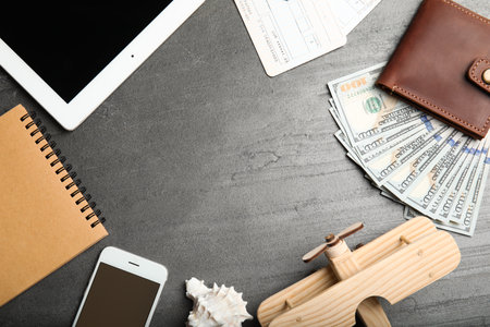 Flat lay composition with tourist items and space for text on gray background. travel agencyの写真素材