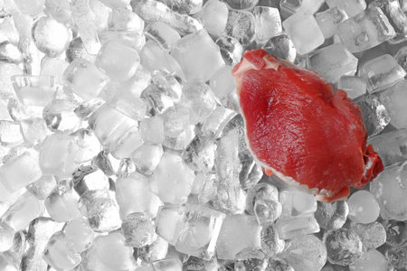 Fresh raw meat on ice cubes, top viewの写真素材