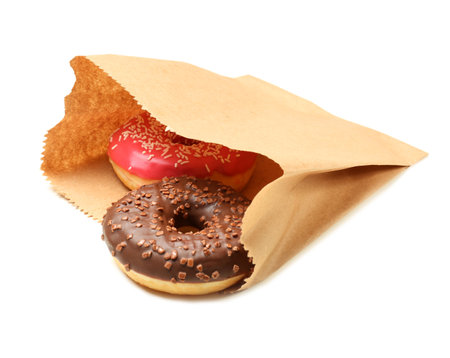 Paper bag with donuts on white background. space for designの写真素材