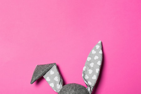 Funny Easter bunny ears on color background, top view with space for textの写真素材