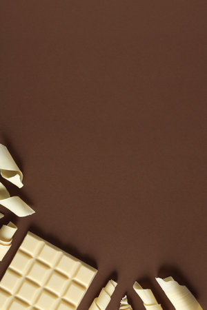 Flat lay composition with chocolate curls and space for text on color backgroundの写真素材