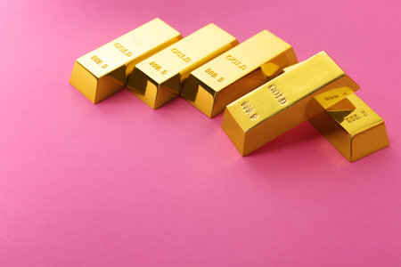 Precious shiny gold bars on color background. Space for textの写真素材