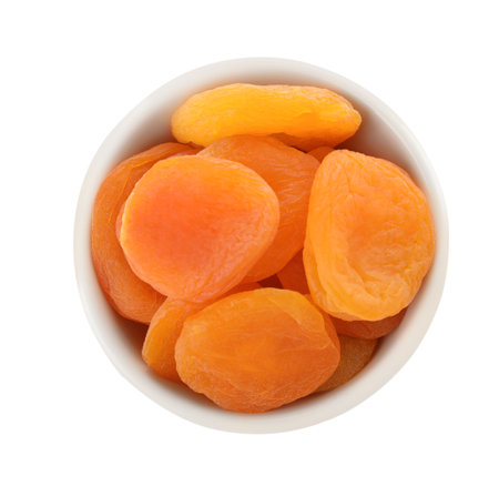 Bowl with apricots on white background, top view. Dried fruit as healthy foodの写真素材