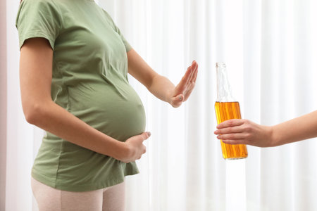 Pregnant woman refusing alcohol drink indoors, closeup. Bad habits during pregnancyの写真素材