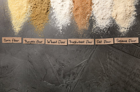 Stripes of different flour types and tags on gray table, top view. Space for textの写真素材