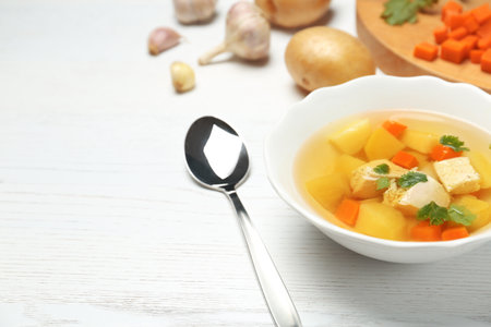 Dish with fresh homemade chicken soup on wooden table, space for textの写真素材