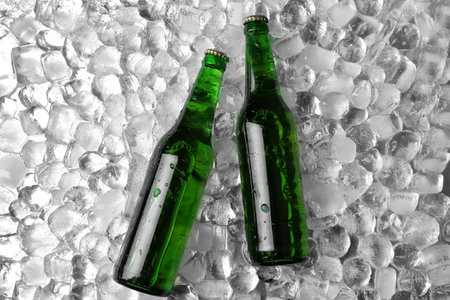 Bottles of beer on ice cubes, flat layの写真素材