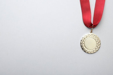 Gold medal with space for design on light background, top view. Victory conceptの写真素材