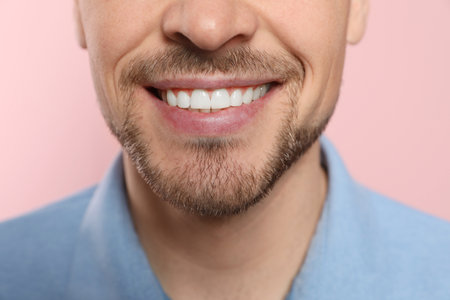 Smiling man with perfect teeth on color background, closeupの写真素材