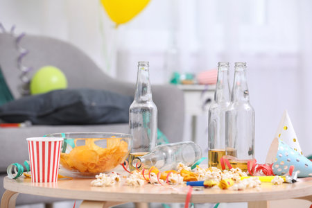 Wooden table with mess after party indoorsの写真素材