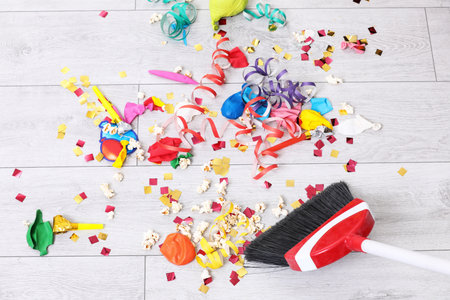 Sweeping trash after party with bristle broom indoorsの写真素材