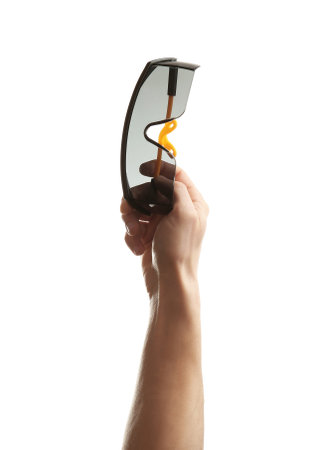 Man holding protective goggles on white background. construction toolsの写真素材