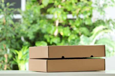 Used cardboard boxes on blurred background. recycling problemの写真素材