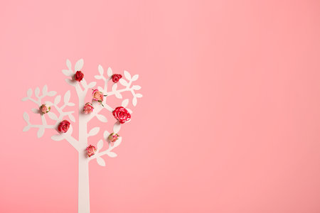 Decorative tree with flowers on color background, space for textの写真素材