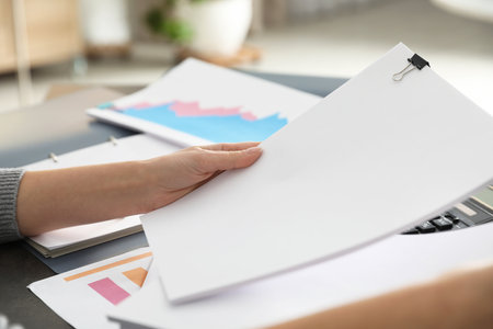 Office employee working with documents at table, closeup. Space for textの写真素材