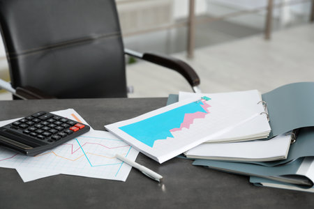 Folders with documents and calculator on office tableの写真素材