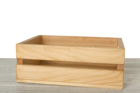 Empty rustic wooden crate on table against white background