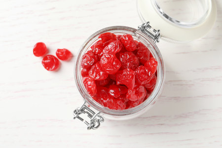 Jar with tasty cherries on wooden background, top view. Dried fruits as healthy foodの写真素材