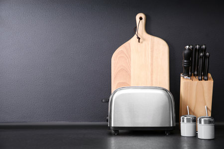 Composition with kitchenware on table against gray background. Space for text
