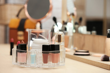 Organizer with cosmetic products and makeup accessories on dressing table. Space for textの写真素材