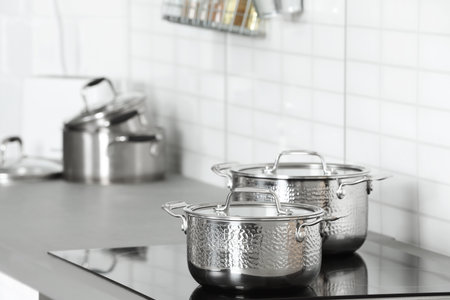 Clean pans on stove in kitchen. Space for textの写真素材