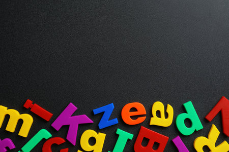Plastic magnetic letters on black background, top view with space for textの写真素材