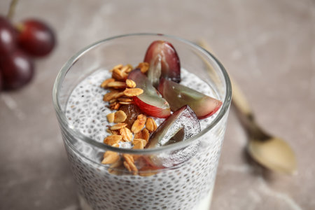 Tasty chia seed pudding with granola and grapes on table, closeupの写真素材