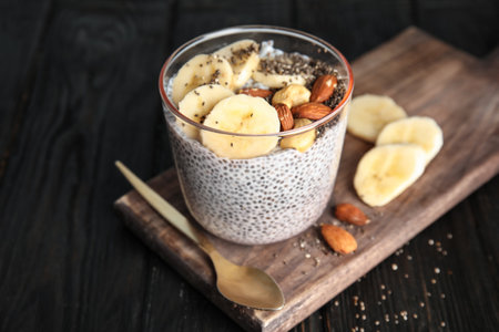 Dessert bowl of tasty chia seed pudding with banana and nuts served on tableの写真素材