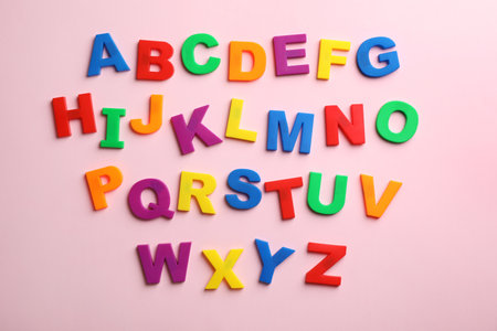 Plastic magnetic letters on color background, top view. alphabetical orderの写真素材