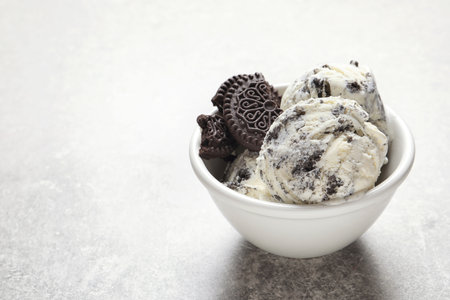Bowl of chocolate cookies ice cream on table. Space for textの写真素材