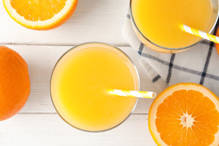Flat lay composition with fresh orange juice on wooden backgroundの写真素材