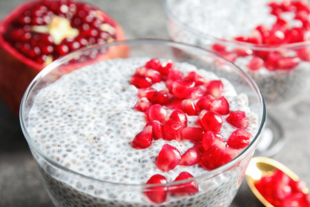 Tasty chia seed pudding with pomegranate in dessert bowl on table, closeupの写真素材