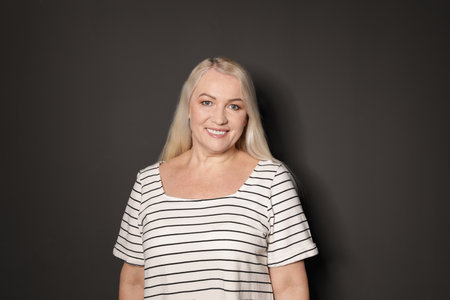 Portrait of mature woman on black background