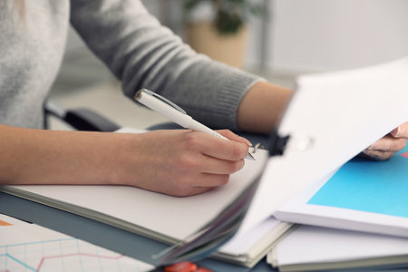 Office employee working with documents at table, closeupの写真素材