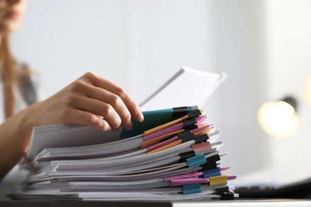 Office employee working with documents at table, closeupの写真素材