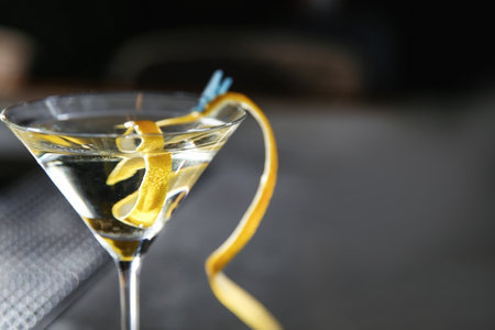 Glass of lemon drop martini cocktail in bar, closeup. Space for textの写真素材